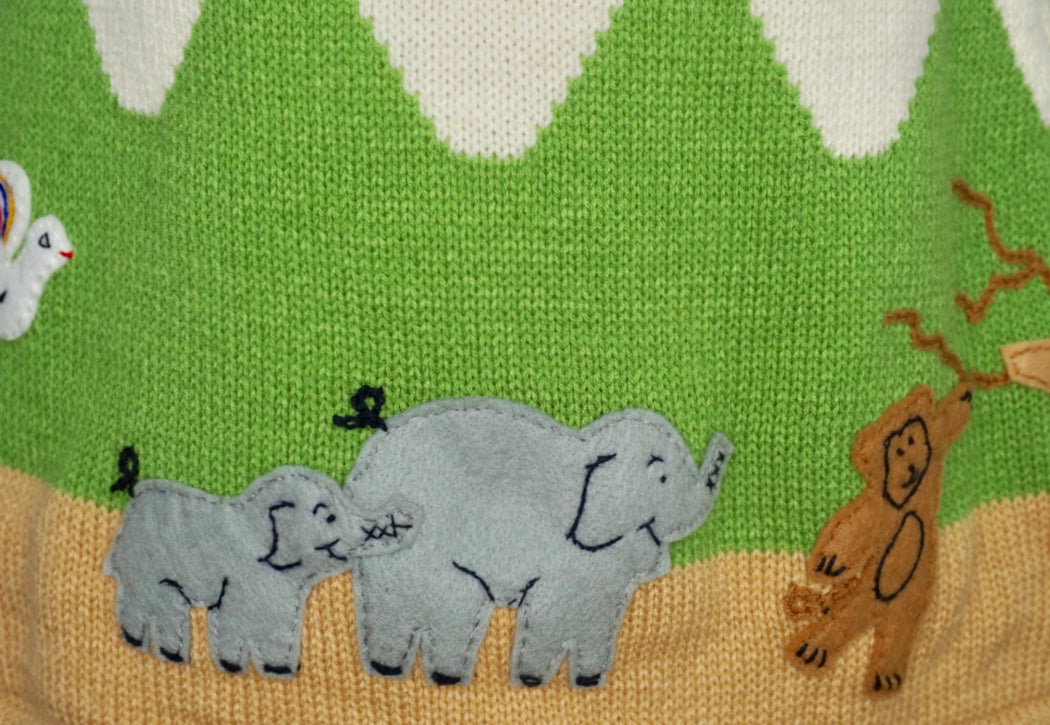 Jungle animal dress, in cream with animals embroidered along the bottom.